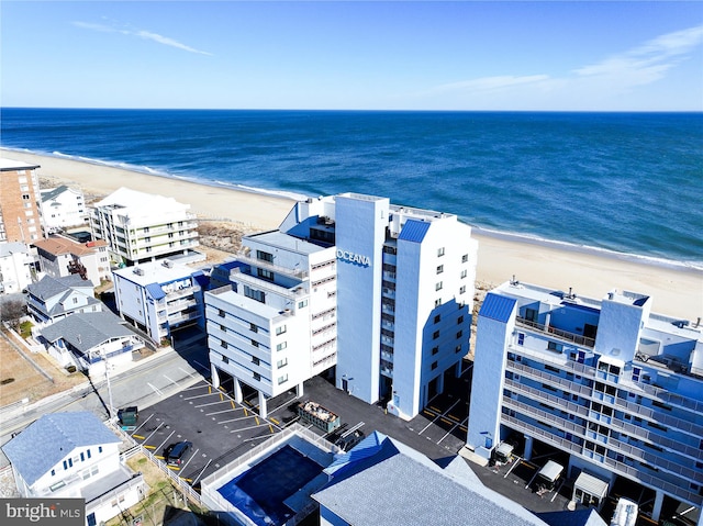 bird's eye view with a water view and a beach view