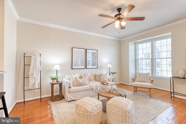 living room featuring ornamental molding, wood-type flooring, and ceiling fan