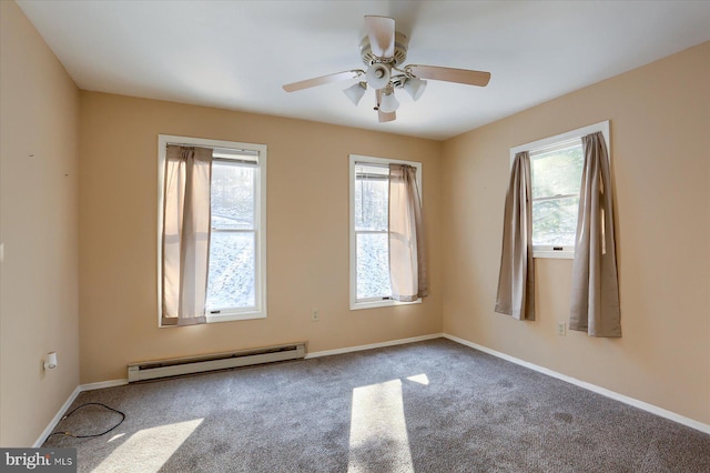 empty room featuring ceiling fan, carpet floors, and a baseboard heating unit