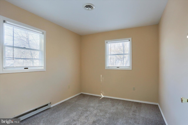 empty room with light colored carpet and baseboard heating