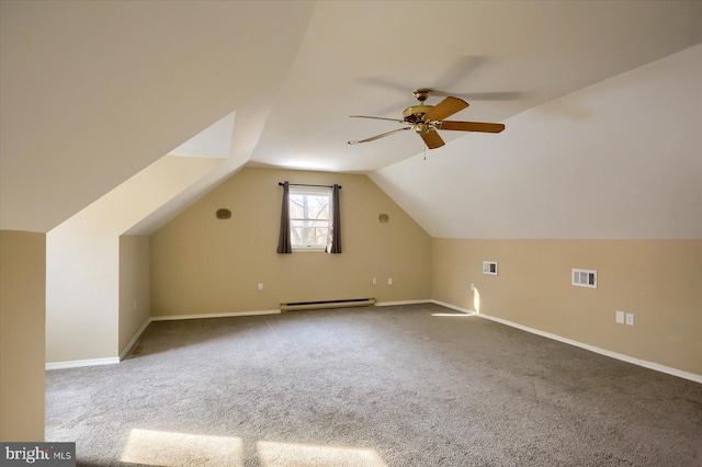 additional living space with baseboard heating, ceiling fan, carpet flooring, and vaulted ceiling