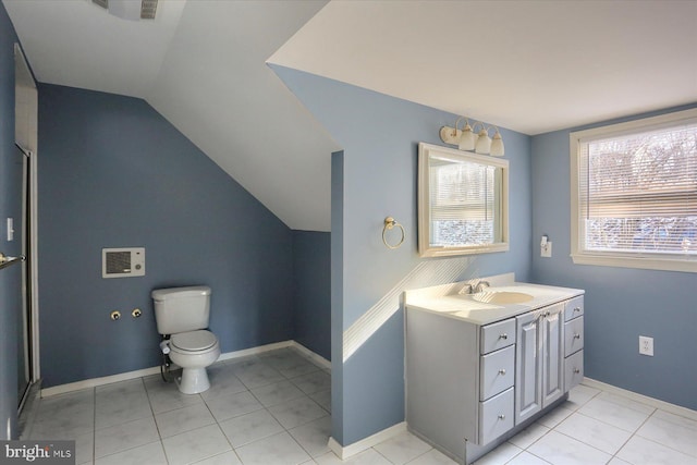 bathroom featuring vanity, vaulted ceiling, tile patterned floors, and toilet