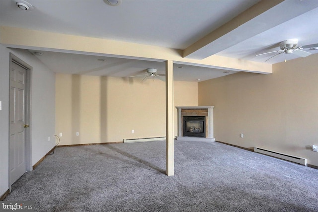 basement featuring a baseboard heating unit, ceiling fan, and carpet