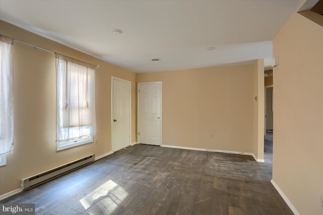 unfurnished room featuring a baseboard heating unit and dark wood-type flooring