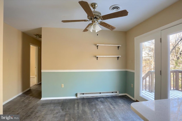 spare room with dark wood-type flooring, a baseboard radiator, and ceiling fan