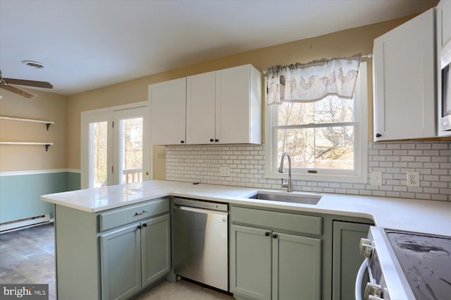 kitchen featuring white cabinets, dishwasher, sink, and white range oven