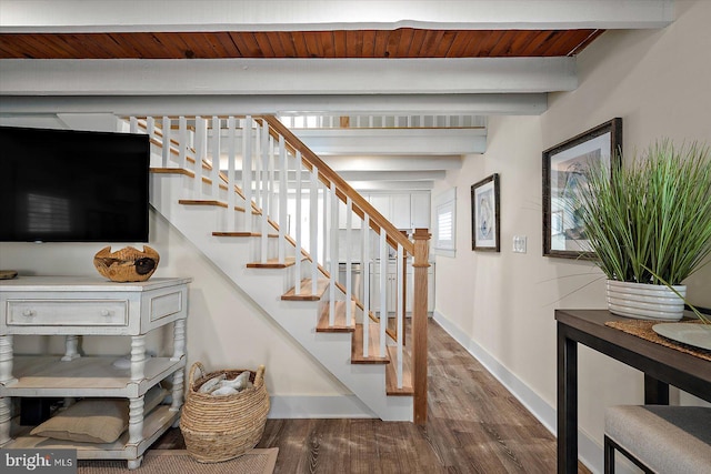 staircase featuring beam ceiling and wood-type flooring