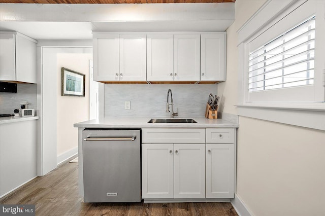 kitchen featuring white cabinetry, dishwasher, and sink