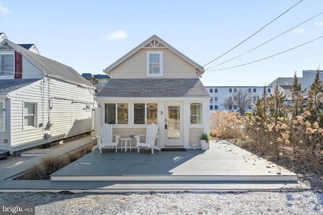 back of house with a wooden deck