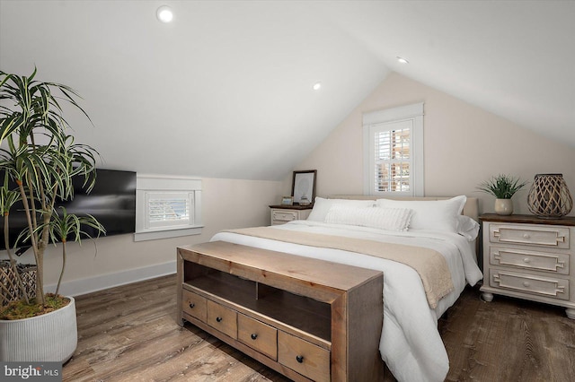 bedroom featuring dark wood-type flooring and vaulted ceiling