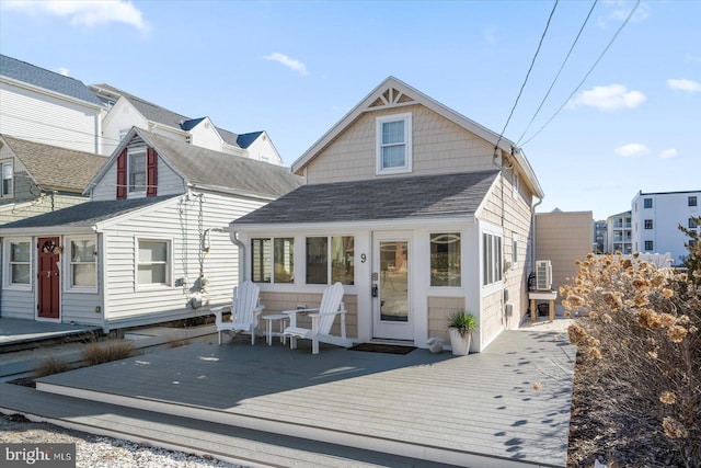 back of property featuring a wooden deck