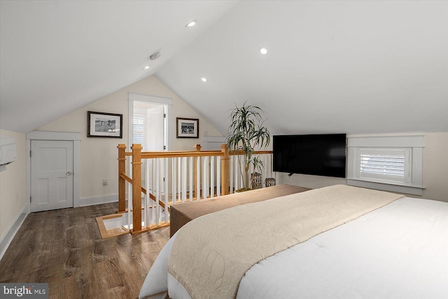 bedroom with dark wood-type flooring, vaulted ceiling, and multiple windows