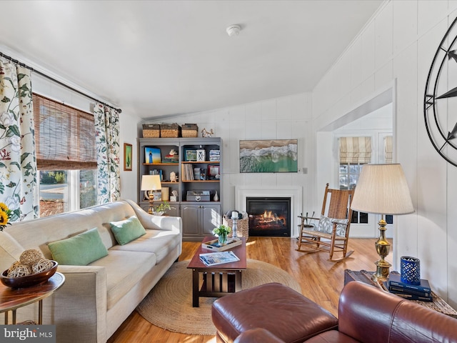 living room with lofted ceiling and light hardwood / wood-style flooring