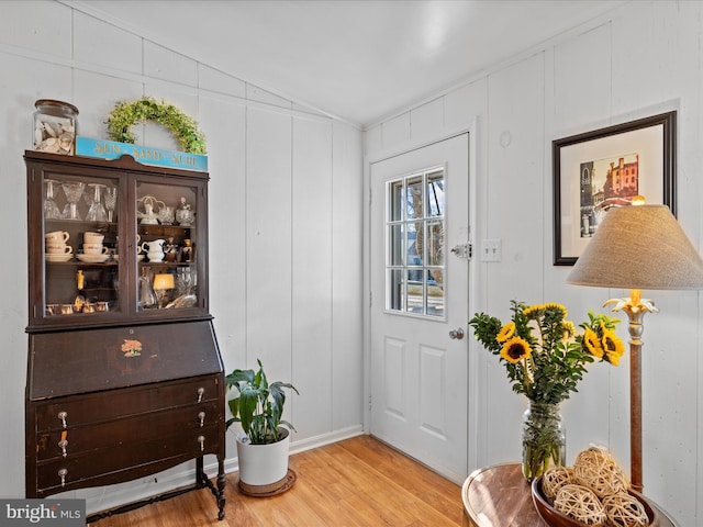 entryway with vaulted ceiling and light hardwood / wood-style floors