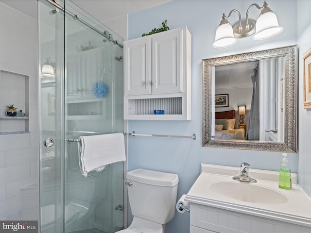 bathroom with vanity, an enclosed shower, and toilet