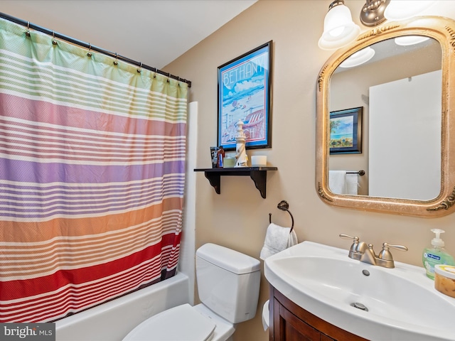 full bathroom with vanity, shower / tub combo with curtain, and toilet