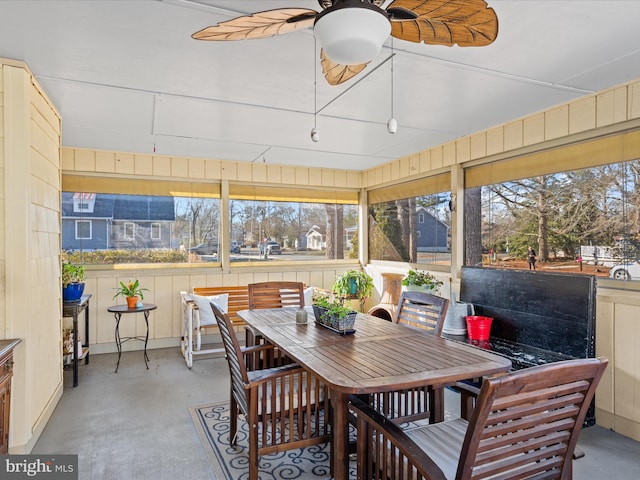 sunroom / solarium with a wealth of natural light and ceiling fan