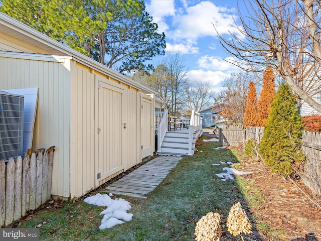 view of yard featuring a deck and central air condition unit