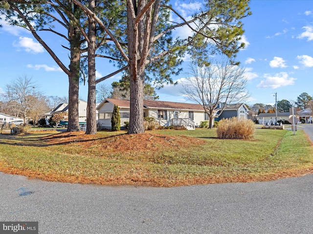 ranch-style home with a front lawn