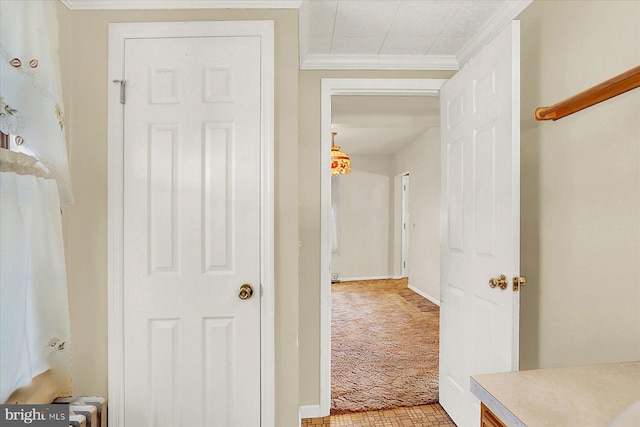 hallway featuring light carpet and crown molding