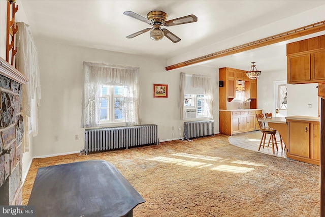 interior space featuring radiator, sink, and ceiling fan