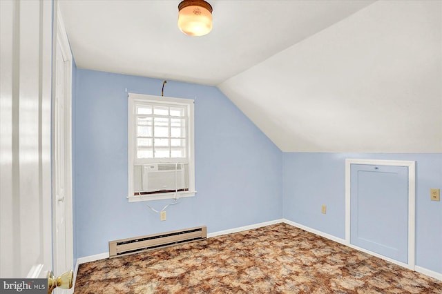 additional living space featuring lofted ceiling, a baseboard heating unit, and carpet