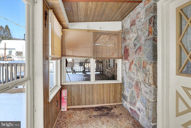 unfurnished sunroom featuring wood ceiling