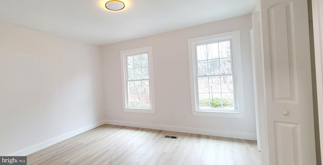 spare room featuring light hardwood / wood-style floors