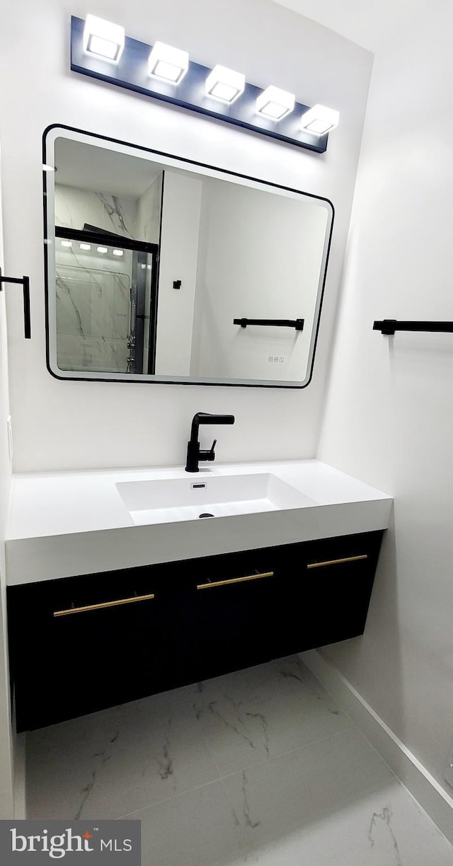 bathroom with vanity and a shower with door