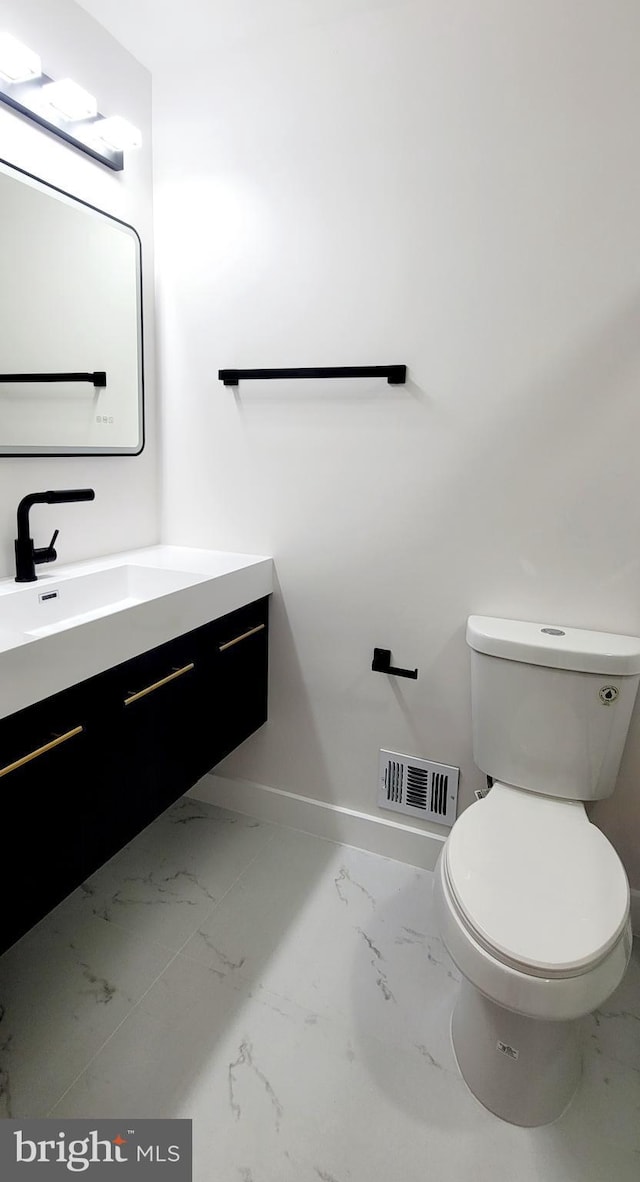 bathroom featuring vanity and toilet