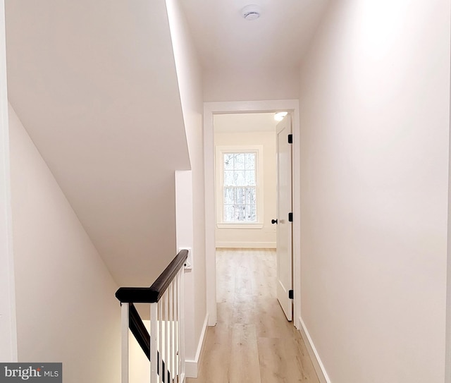 corridor with light hardwood / wood-style flooring