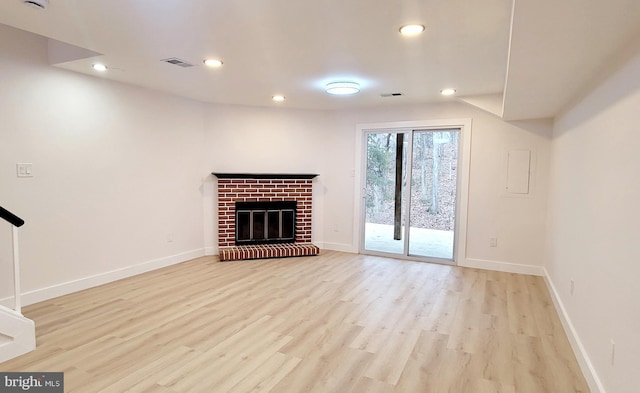 unfurnished living room featuring a fireplace and light wood-type flooring