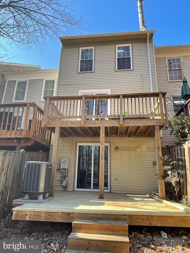 back of house with a wooden deck, a balcony, and central AC unit