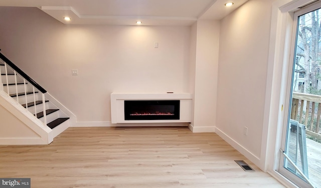 unfurnished living room with light hardwood / wood-style flooring