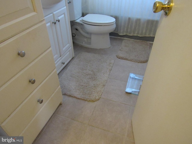 bathroom with vanity, toilet, and tile patterned flooring