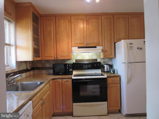 kitchen featuring sink, light tile patterned floors, white appliances, and decorative backsplash