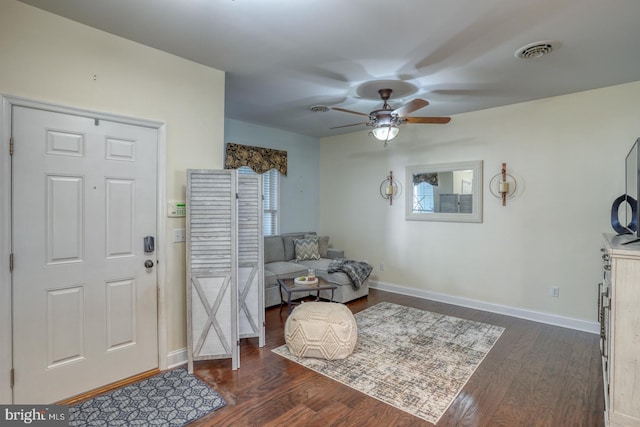 entryway featuring dark wood-type flooring, ceiling fan, and a wealth of natural light