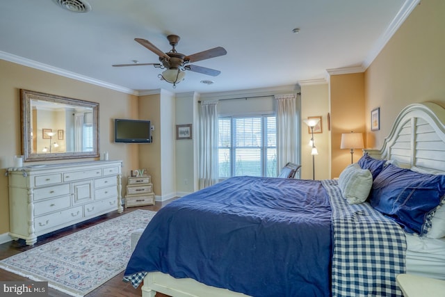 bedroom featuring dark hardwood / wood-style flooring, ornamental molding, and ceiling fan