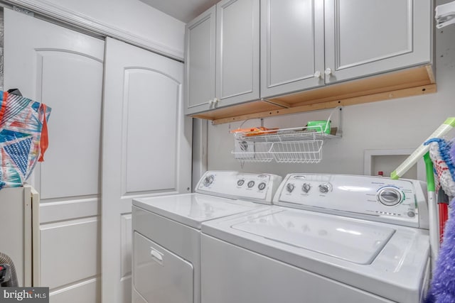 laundry room featuring cabinets and separate washer and dryer