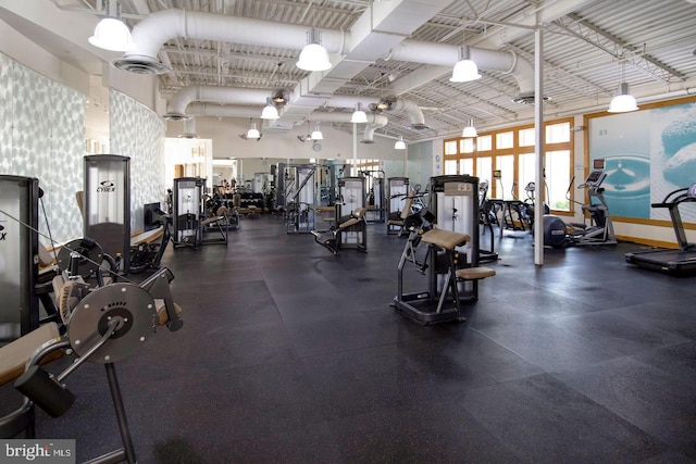 workout area with a towering ceiling