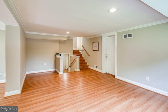 unfurnished room with crown molding and light hardwood / wood-style floors