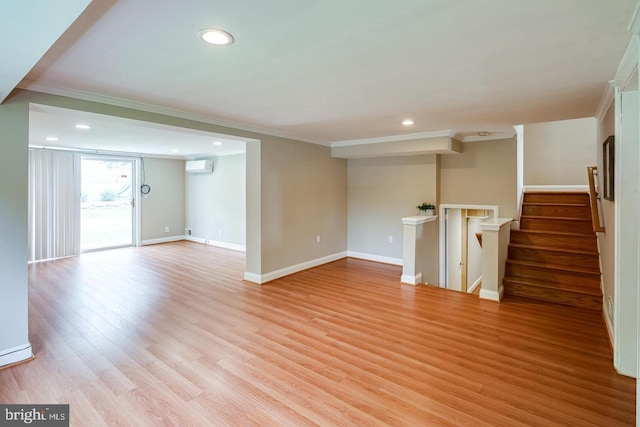 unfurnished living room featuring ornamental molding, an AC wall unit, and light hardwood / wood-style floors