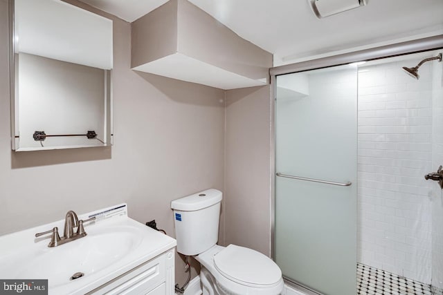 bathroom with vanity, toilet, and a shower with shower door