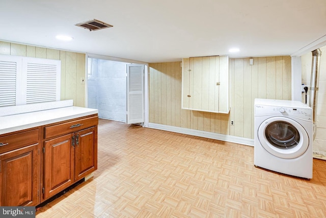 washroom with washer / clothes dryer and light parquet flooring