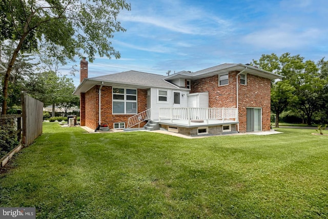 back of house with a yard and a deck