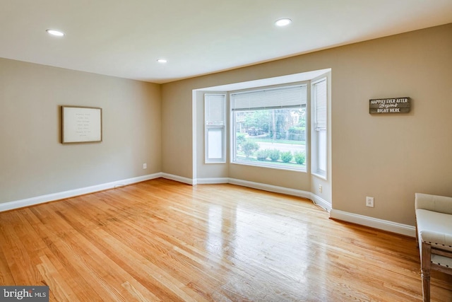 spare room featuring light hardwood / wood-style floors