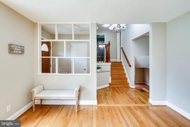 living area with hardwood / wood-style flooring and a chandelier