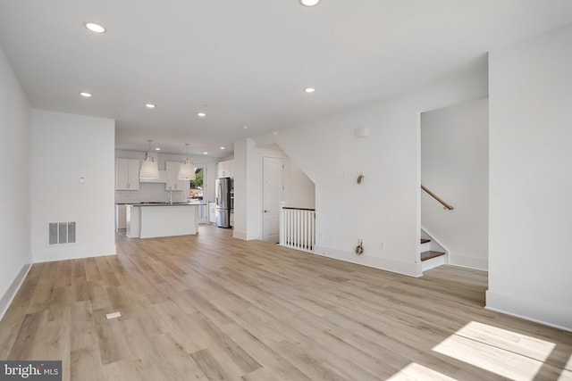 unfurnished living room with light wood-type flooring