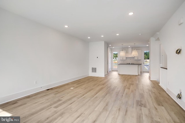 unfurnished living room featuring light hardwood / wood-style floors