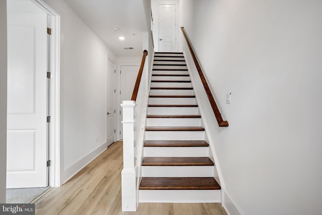 stairway featuring wood-type flooring